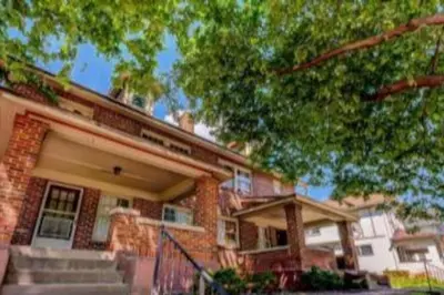 a brick house with a tree in front of it at Sleeps up to 20 in Dayton with 6 Bedrooms plus 2 Full Kitchens in Dayton