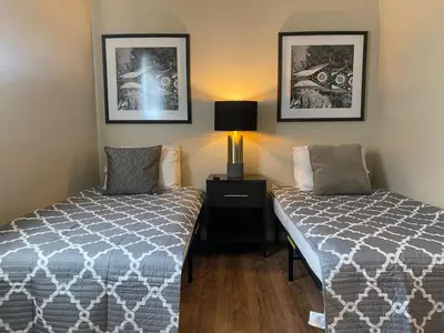a bedroom with two beds and a lamp and pictures at Crew Housing Sleeps 8 with 6 Beds plus 4 Bedrooms in Dayton