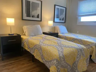 a hotel room with two beds and two lamps at Crew Housing Sleeps 8 with 6 Beds plus 4 Bedrooms in Dayton
