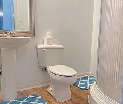a bathroom with a white toilet and a sink at Crew Housing Sleeps 8 with 6 Beds plus 4 Bedrooms in Dayton