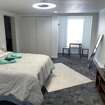 a bedroom with a bed and a dresser and a window at The Haven in Toledo