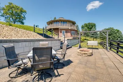 a patio with chairs and a fire pit in front of a building at Millersburg Getaway with Amish Country Views! in Millersburg