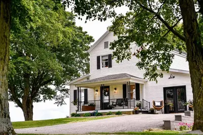 a white house with black shutters at The Bidwell Bungalow in Amanda