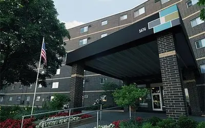 a building with an american flag in front of it at Scenic towers 3020 I Cozy & Comfy I Free Parking in Parma
