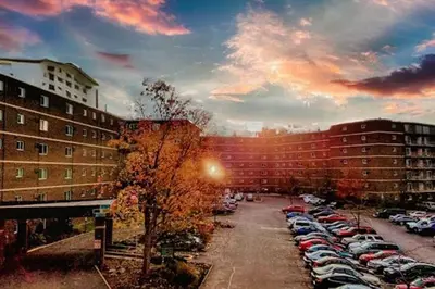 a parking lot with cars parked in a parking lot at Scenic towers 3020 I Cozy & Comfy I Free Parking in Parma