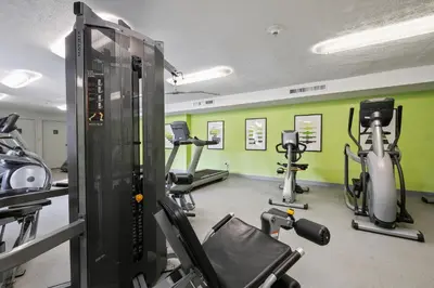 a gym with several treadmills and exercise bikes at Scenic towers 3105I Cozy & Comfy I Free Parking in Parma