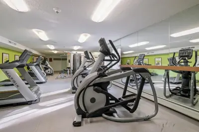 a gym with treadmills and elliptical machines at Scenic towers 3105I Cozy & Comfy I Free Parking in Parma