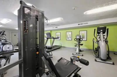 a gym with several tread machines in a room at Scenic towers 3217I Cozy & Comfy I Free Parking in Parma