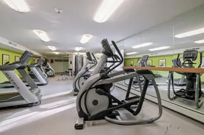 a gym with treadmills and elliptical machines at Midtown 3402I Cozy & Comfy I Free Parking in Parma