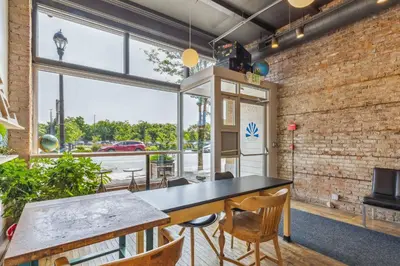 a room with a table and chairs and a large window at The Victor 3 - Cleveland's Urban Lodge in Cleveland