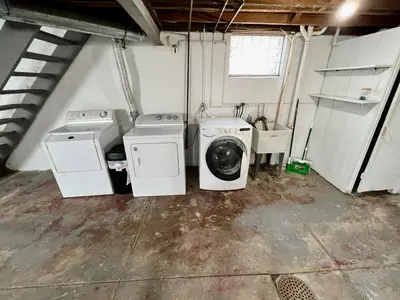 a laundry room with two washing machines and a sink at Cozy Bungalow Quiet Neighborhood Queen Bed Suite 3 10 Min to Downtown in Cincinnati