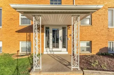 awning over a front door of a brick building at Heights Sweet - Libby Unit 7 in Maple Heights