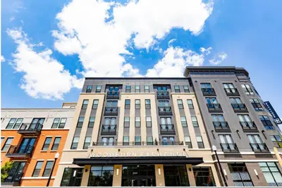 a building with a sign on the front of it at Cozy 10BR 10BA combined Apartment Near Downtown Cincinnati in Cincinnati