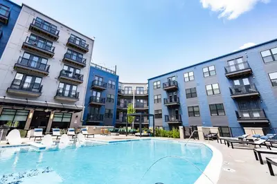 a large swimming pool in front of some buildings at Cozy 6BR 6BA combined Apartments Near Downtown Cincinnati in Cincinnati