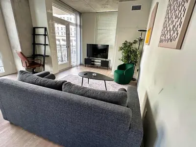 a living room with a couch and a table at Brand new 4BR 3BA Combined apartments with city views in Cleveland