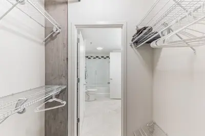 a room with a toilet and a walk in closet at 4 Brand new combined apartments with city views in Cleveland