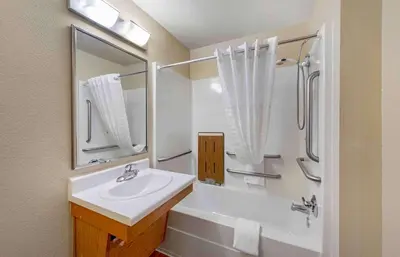 a white bathroom with a sink and a shower at Extended Stay America Select Suites - Dayton - Miamisburg in Dayton
