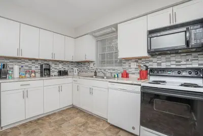 a kitchen with white cabinets and a stove top oven at Ashwood Arbor 3 bed 2 bath sleeps 8 in Olde West Chester
