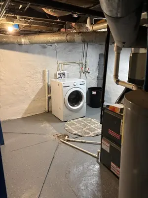 a laundry room with a washing machine in a building at Cozy Studio Private room in Cincinnati