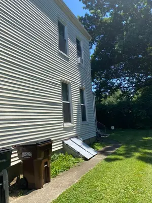 a house with a ramp next to a building at Cozy Studio private room deluxe in Cincinnati