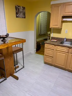 a kitchen with wooden cabinets and a counter top at Cozy Studio private room deluxe in Cincinnati