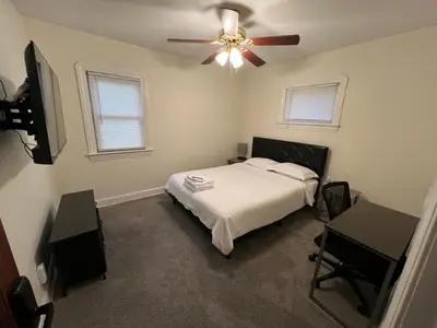 a bedroom with a bed and a ceiling fan at StayWithJay Premium Furnished Room near Cleveland Airport in Cleveland