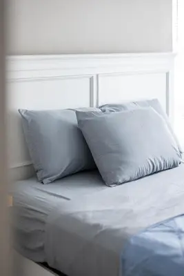 a bed with two pillows on top of it at Luxury Downtown Townhome Private Garage Unit 4 in Cleveland