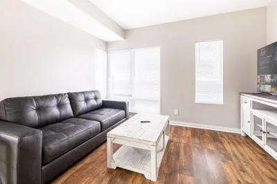 a living room with a leather couch and a coffee table at Luxury Downtown Townhome Private Garage Unit 6 in Cleveland
