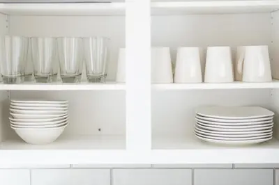 a white kitchen shelf with plates and bowls at Luxury Downtown Townhome Private Garage Unit 6 in Cleveland