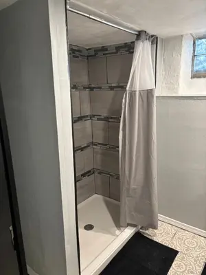 a shower in a bathroom with a shower curtain at Private tiny room for one in Cincinnati
