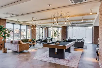 a living room with a pool table in the middle at OTR King Bed Free Parking Gym Top Floor Club Room in Cincinnati