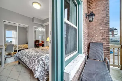 a bedroom with a bed and a large window at Cle Suites 2BR 1BA 5 min Walk to Cle Clinic Unit 5 in Cleveland