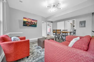 a living room with two red chairs and a table at Cle Suites 2BR 1BA 5 min Walk to Cle Clinic Unit 5 in Cleveland