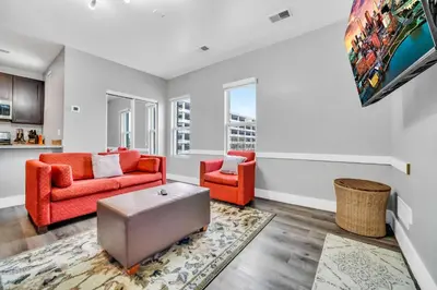 a living room with two orange chairs and a rug at Cle Suites 2BR 1BA 5 min Walk to Cle Clinic Unit 5 in Cleveland