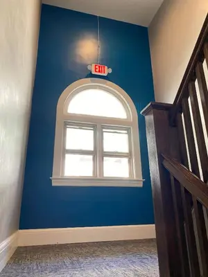 a room with a blue wall with an arched window at Cle Suites 1BR 1BA 5 min Walk to Cle Clinic #7 in Cleveland