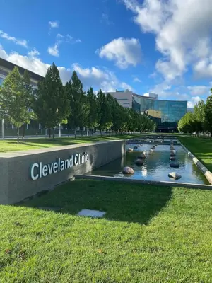 a fountain in front of a building with a sign at Cle Suites 2BR 1BA 5 min Walk to Cle Clinic #8 in Cleveland