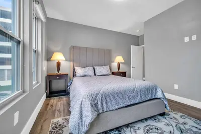 a bedroom with a bed and two lamps and a window at Cle Suites 2BR 1BA 5 min Walk to Cle Clinic #12 in Cleveland