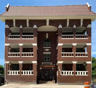 a red brick building with a red roof at Cle Suites 2BR 1BA 5 min Walk to Cle Clinic #14 in Cleveland