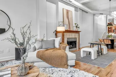 a living room with a white couch and a fireplace at Lofts on 4th Penthouse, Sleeps 14, 2 units in Cleveland