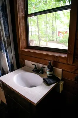 a bathroom with a sink and a window at Luxury Conestoga Wagon, Perfect for a Weekend Glamping Escape from Dayton, Ohio