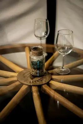 two wine glasses and a jar on a wooden table at Ohio Glamping Destination in this Covered Wagon in Arcanum