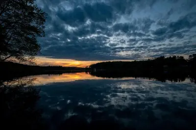 a view of a lake with a cloudy sky at Impressive Tented Cabin with Peaceful Vistas and Fire Pit in Logan, Ohio in Logan