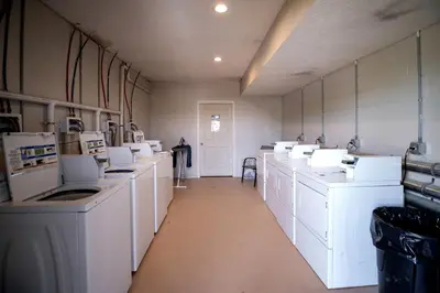 a large laundry room with white washers and dryers at Impressive Tented Cabin with Peaceful Vistas and Fire Pit in Logan, Ohio in Logan