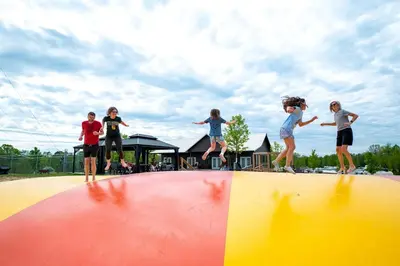 a group of children jumping on top of a ramp at Sensational Tented Cabin Nestled Amidst Trees and Fire Pit Provided in Logan, Ohio in Logan