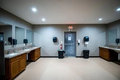 a bathroom with two sinks and a door in a room at Charming Tented Cabin Placed in a Selcuded Area in Logan, Ohio in Logan