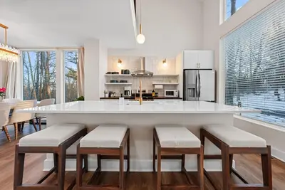 a kitchen with a large white island with stools at Adamina Canyon Luxurious 5BR 3BTH 2 in Rockbridge