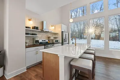 a kitchen with white cabinets and a large window at Adamina Canyon Luxurious Villa with Wellness room 5 in Rockbridge