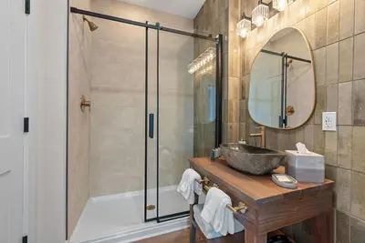 a bathroom with a tub and a sink and a mirror at Adamina Canyon Luxurious, Brand New 5BR 3BTH 7 in Rockbridge