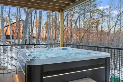 a hot tub on a balcony with a view of trees at Adamina Canyon Luxurious, Brand New 5BR 3BTH 7 in Rockbridge