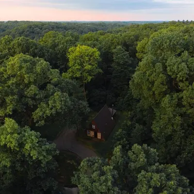 an overhead view of a house in the middle of a forest at A-Frame #01 - by The Chalets in Logan